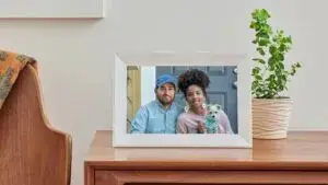 Marco digital Aura con tecnología de tinta electrónica mostrando fotografías familiares en un hogar moderno